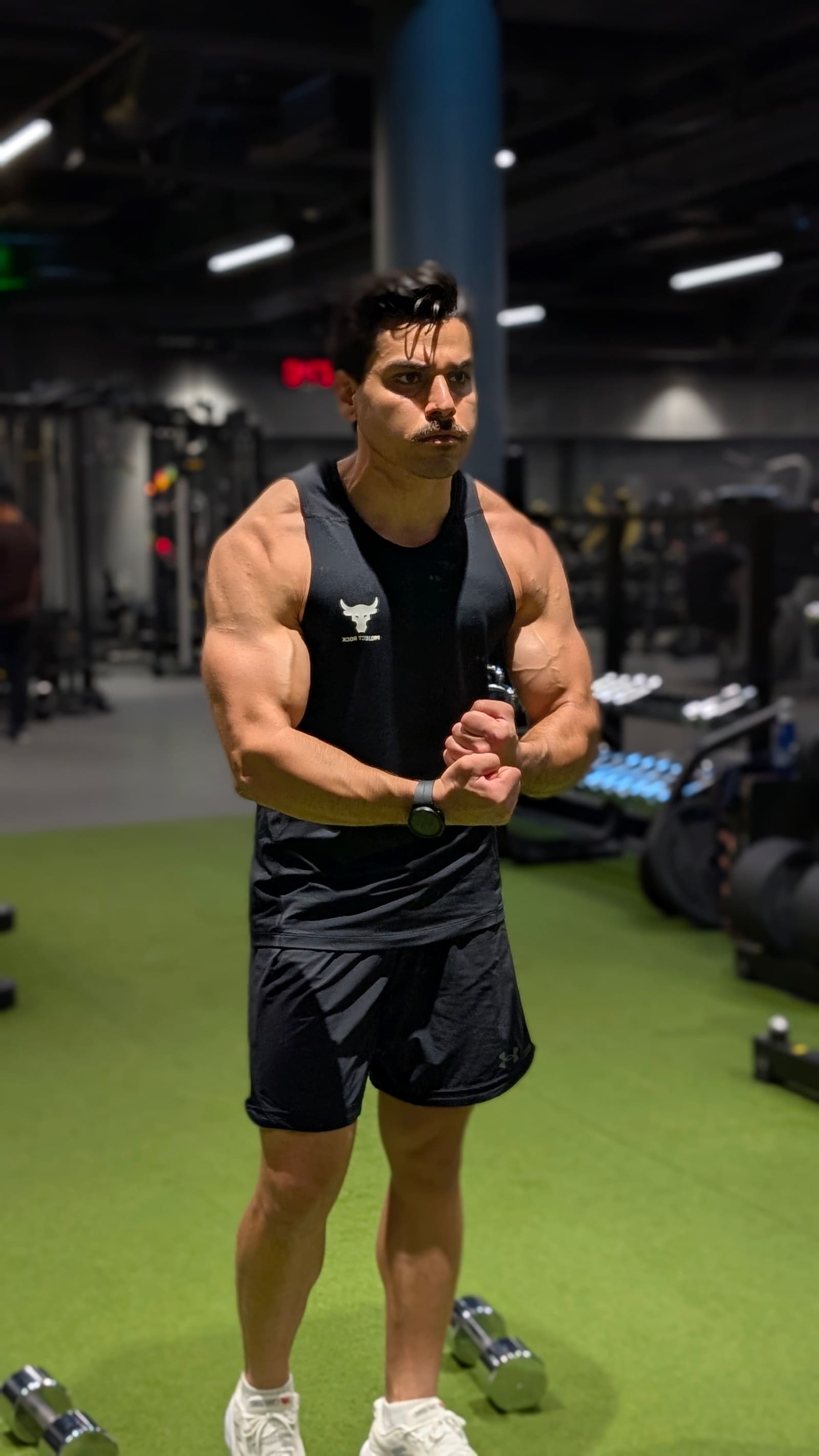 Samy lifting weights in the gym